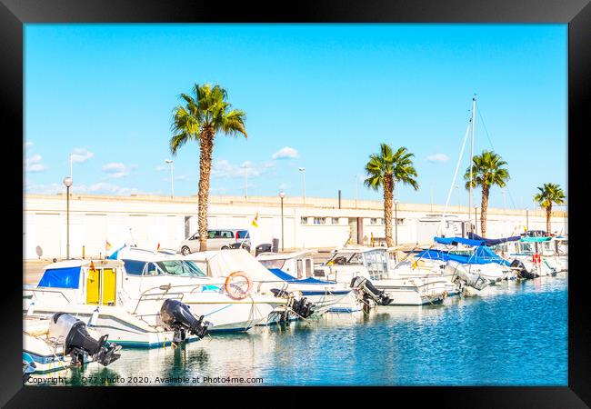 Beautiful luxury yachts and motor boats anchored in the harbor, hot summer day and blue water in the marina, blue sky Framed Print by Q77 photo