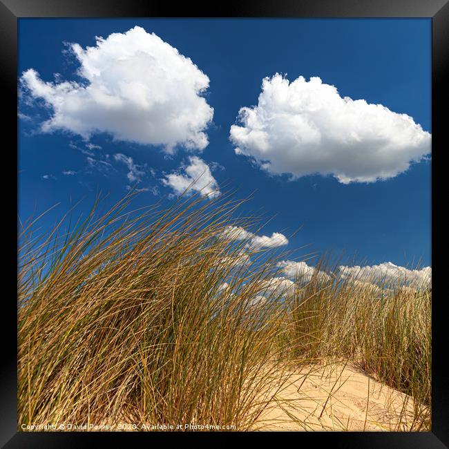 Clouds above the sand dunes Framed Print by David Powley