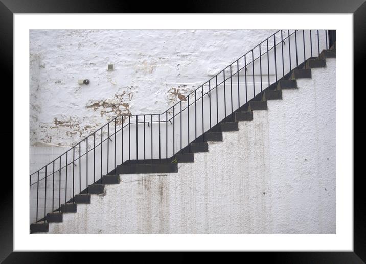 Black stairs on white wall Framed Mounted Print by Theo Spanellis