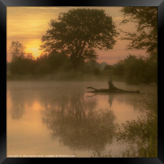Mist over a pond at sunrise Framed Print by Clive Ingram