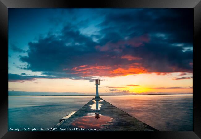 Light beacon and pier on Gironde estuary at sunset Framed Print by Stephen Rennie