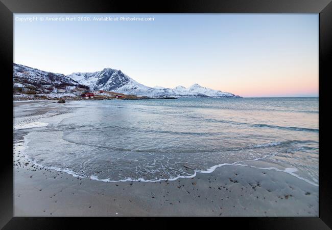 Snowy mountains from a beach in Norway Framed Print by Amanda Hart