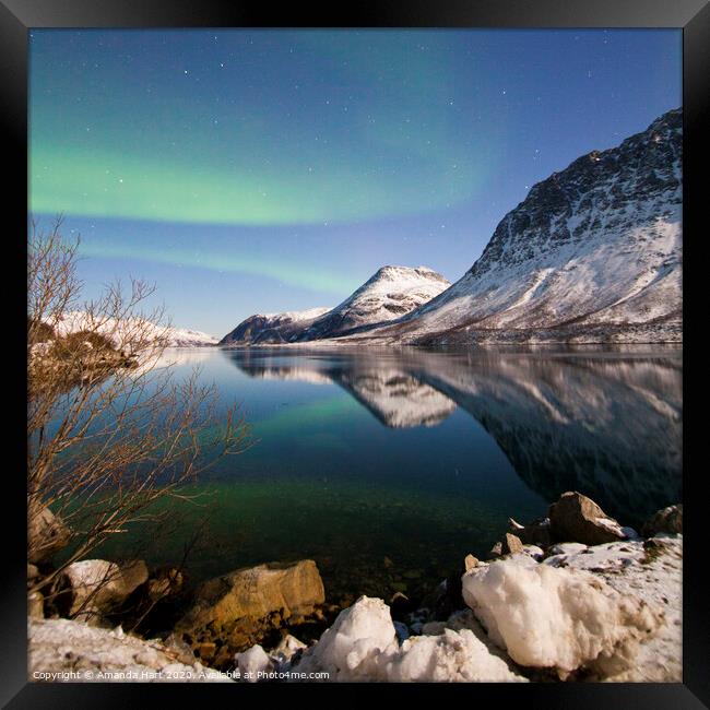 Northern lights over a fjord in Norway Framed Print by Amanda Hart