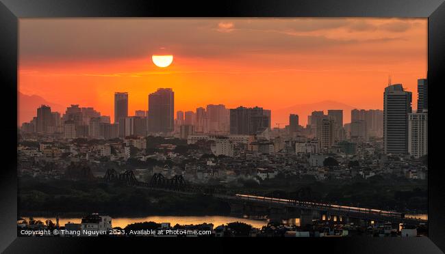 Sunset over Long Bien bridge with a train homing i Framed Print by Thang Nguyen