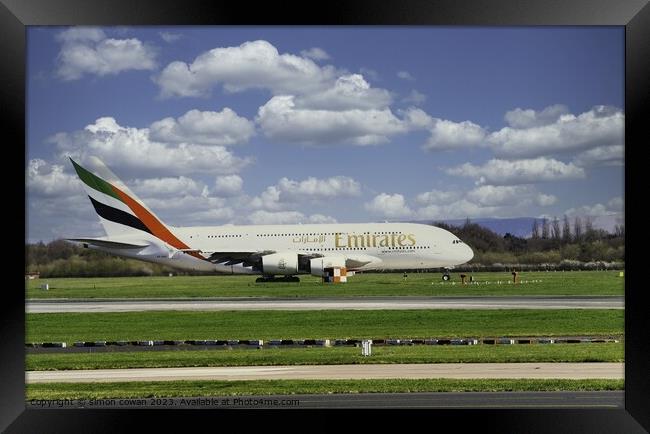 Emirates getting ready for take off Framed Print by simon cowan
