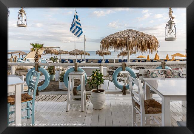 greek restaurant with blue and white tables right on the beach w Framed Print by Stig Alenäs