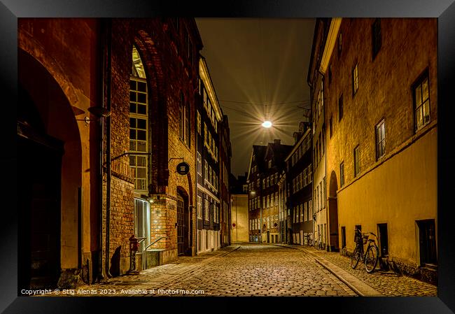 street lamp hanging over an alley at night in Copenhagen Framed Print by Stig Alenäs