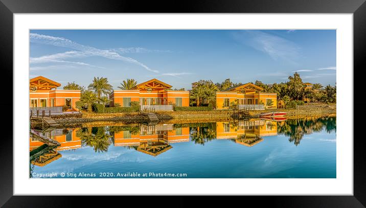 Real estate villas at the edge of a blue lagoon Framed Mounted Print by Stig Alenäs