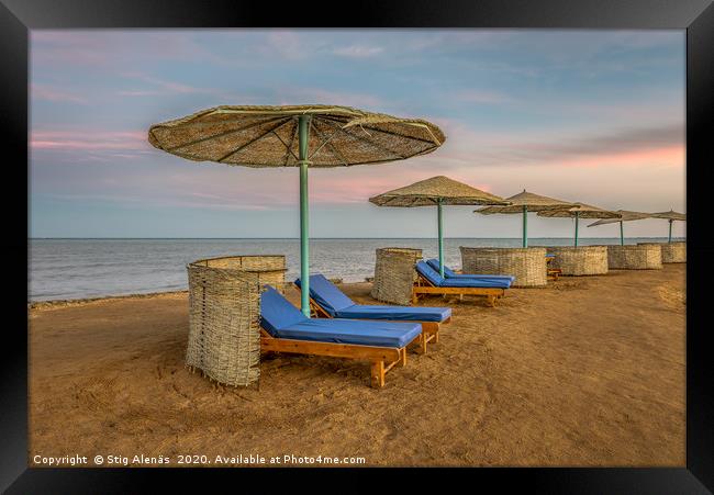 loungers and shelters in a row at the sunset on a  Framed Print by Stig Alenäs
