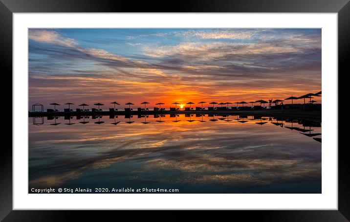 tiny elongated island with umbrellas in the sunset Framed Mounted Print by Stig Alenäs