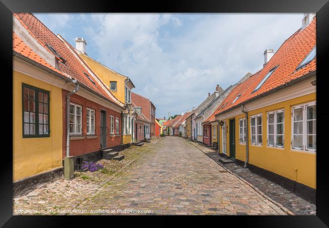 an idyllic street with cobblestone and old houses  Framed Print by Stig Alenäs