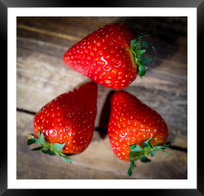 Strawberries on a wooden table in close-up Framed Mounted Print by Erik Lattwein