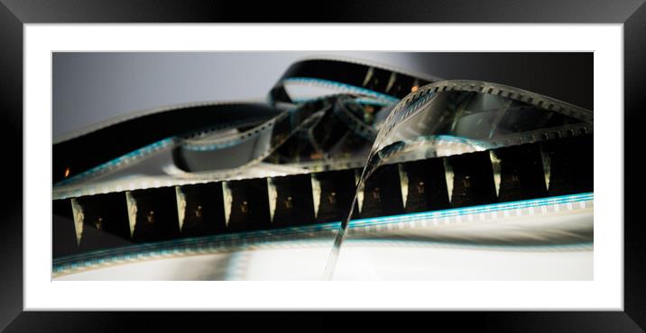 Close Up view of a 35mm film strip - macro shot Framed Mounted Print by Erik Lattwein