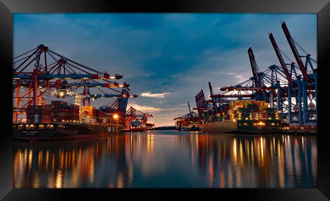 Huge loading cranes in the port of Hamburg by night - CITY OF HAMBURG, GERMANY - MAY 10, 2021 Framed Print by Erik Lattwein