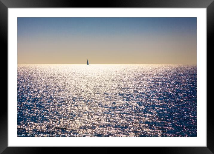 A backlit sailboat at sea Framed Mounted Print by Jordi Carrio