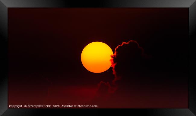 Sunset against reddish sky with back lit cloud Framed Print by Przemek Iciak