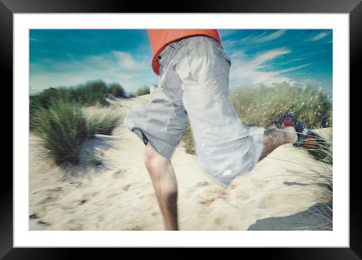 blurry photo of man legs running through sand Framed Mounted Print by federico stevanin