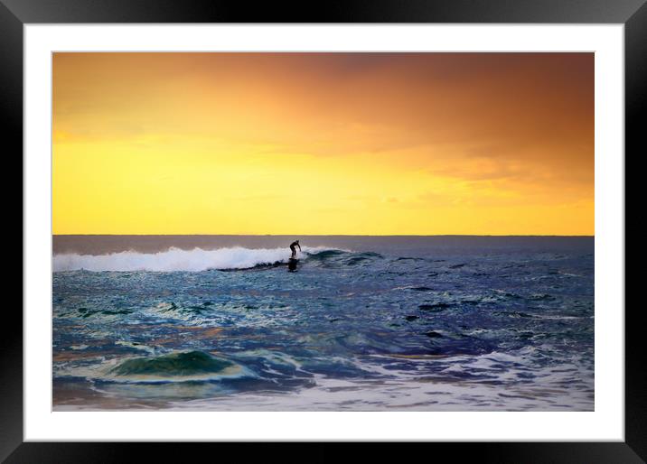  lone surfer rides the wave of the ocean at sunset Framed Mounted Print by federico stevanin