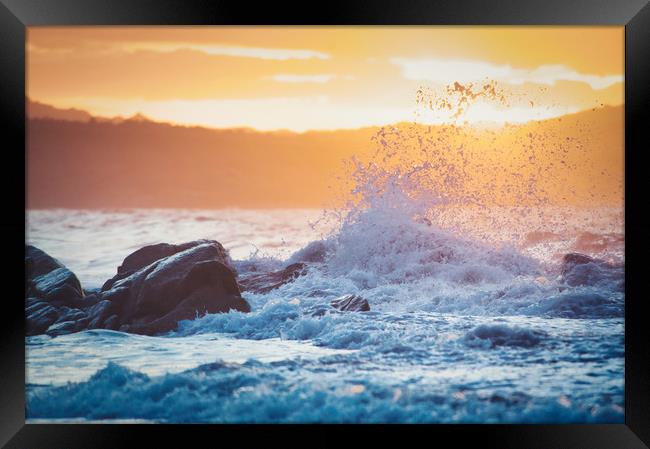 wave breaking on the rocks at sunset Framed Print by federico stevanin