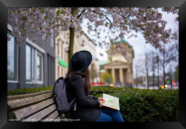 Woman looking at the Brandenburger Tor sited on a bank in Berlin, Germany Framed Print by Luis Pina