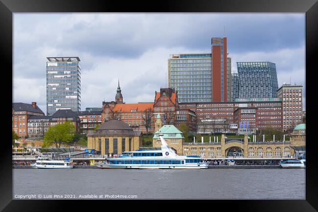 View of St. Pauli's Pier Landungsbrücken station tower with buildings and boats in Hamburg Framed Print by Luis Pina