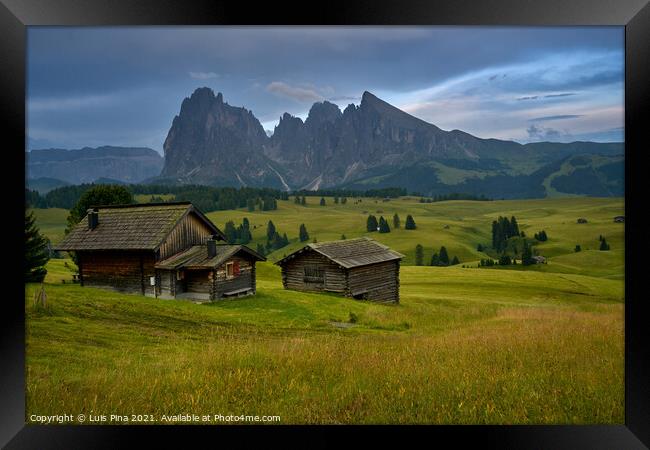 Sassolungo mountains on the Italian Alps Dolomites with wood houses on the foreground Framed Print by Luis Pina