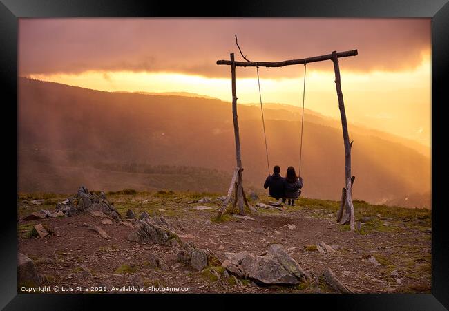 Romantic couple social distancing swinging on a Swing baloico in Lousa mountain, Portugal at sunset Framed Print by Luis Pina