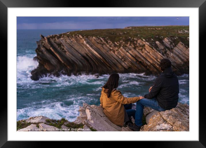 Couple caucasian female and male holding hands looking at cliff landscape with ocean waves in Baleal Island, Peniche, Portugal Framed Mounted Print by Luis Pina