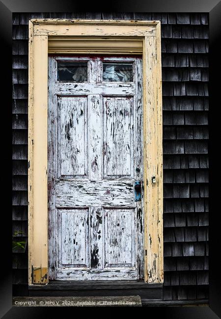 Old wooden door with weathered paint Framed Print by Miro V