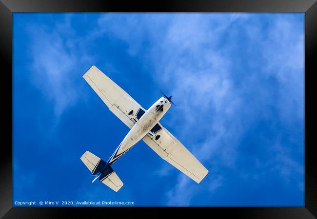 Small Aeroplane with blue sky and light clouds Framed Print by Miro V