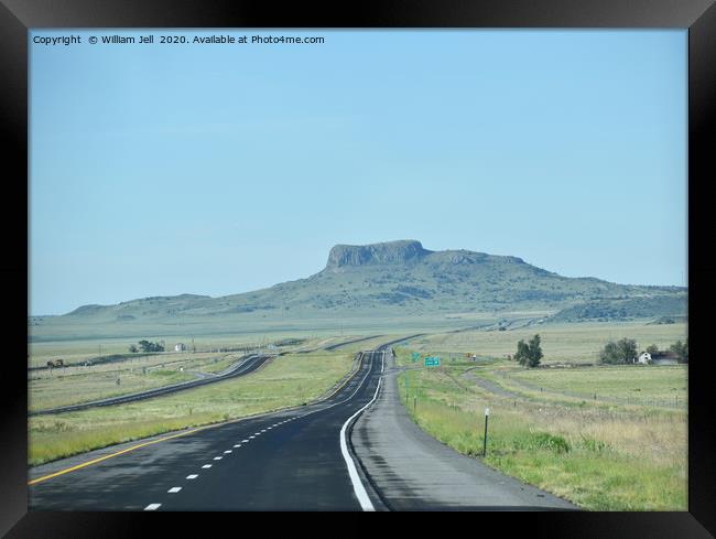 Endless ribbon of blacktop heading towards a mesa  Framed Print by William Jell