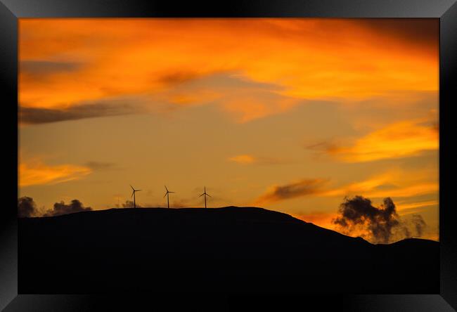 Clean energy power concept with wind turbine on top of a mountain during dramatic sunset Framed Print by Arpan Bhatia