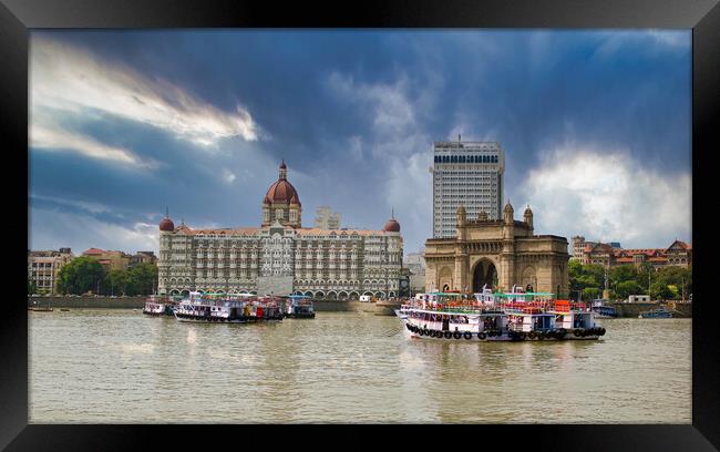 Mumbai, India: Wide angle shot of Gateway of India and Taj hotel against sea and dramatic cloudy sky Framed Print by Arpan Bhatia