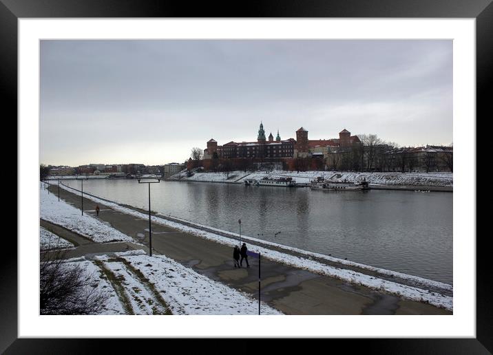 Krakow, Poland - January 29, 2015: Wide angle view of famous wawel castle covered with snow next to vistual river against cloudy sky Framed Mounted Print by Arpan Bhatia