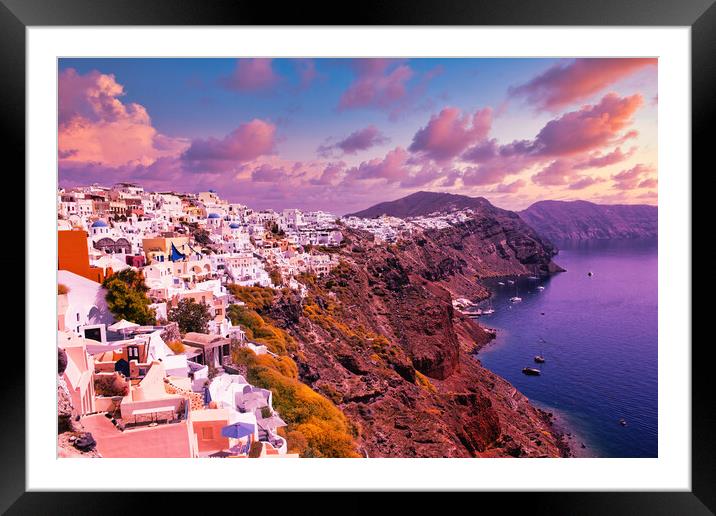 Santorini, Greece: Beautiful city of Oia ( Ia ) on a hill of white houses with blue roof against dramatic pink sky, located in Greek Cyclades islands in Mediterranean sea Framed Mounted Print by Arpan Bhatia