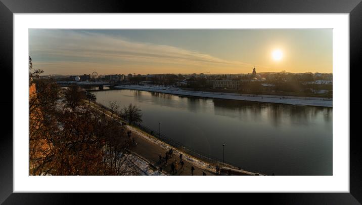 Krakow, Poland - January 31, 2021: Panorama aerial shot of Cracow cityscape next to Vistula river during sunset in Winter with people doing leisure. Framed Mounted Print by Arpan Bhatia
