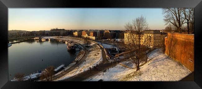 Krakow, Poland - January 31, 2021: Panorama aerial drone shot of Cracow cityscape and polish architecture next to Vistula river during sunset in Winter with people doing leisure and walk in the evening. Framed Print by Arpan Bhatia