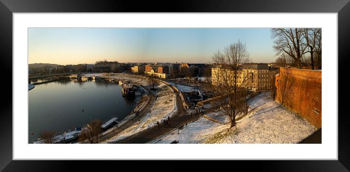 Krakow, Poland - January 31, 2021: Panorama aerial drone shot of Cracow cityscape and polish architecture next to Vistula river during sunset in Winter with people doing leisure and walk in the evening. Framed Mounted Print by Arpan Bhatia