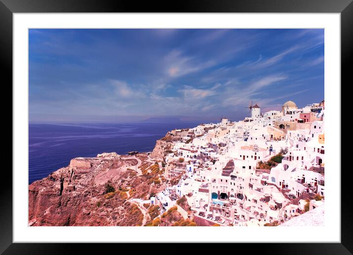 Santorini, Greece - September 11, 2017: Wide angle panoramic view of Oia Santorini white buildings on the hillside facing north against the blue sky. Cityscape of famous greek island Framed Mounted Print by Arpan Bhatia