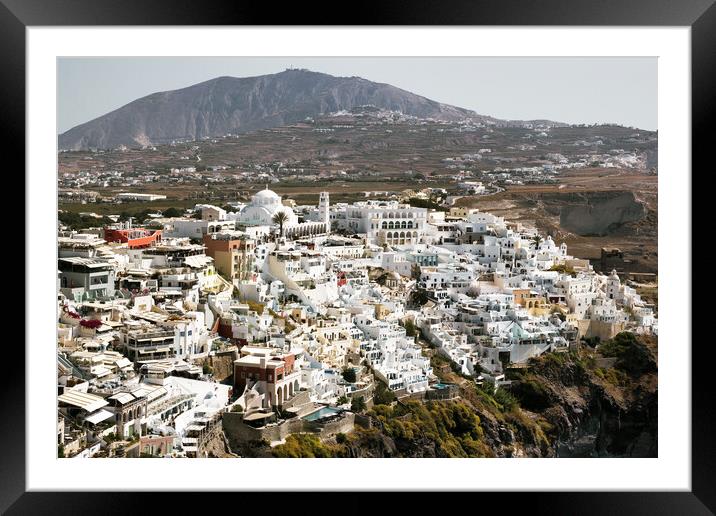 Drone Aerial shot of Thira village in Santorini, Oia located in Greece against mountains. Famous greek island cityscape Framed Mounted Print by Arpan Bhatia
