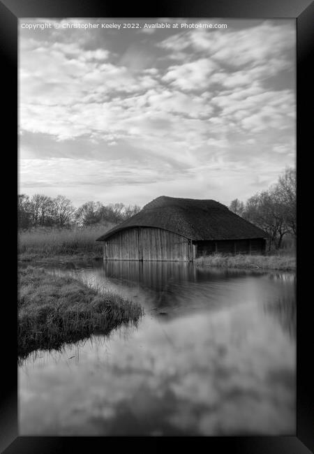 Hickling Broad boat house in black and white Framed Print by Christopher Keeley