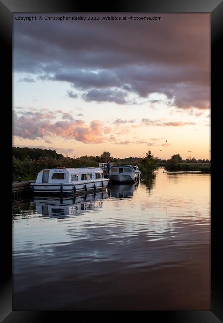 Sunset over Norfolk Broads boats Framed Print by Christopher Keeley