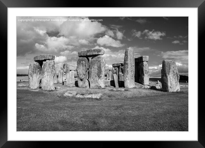 Cloudy skies over Stonehenge in black and white Framed Mounted Print by Christopher Keeley