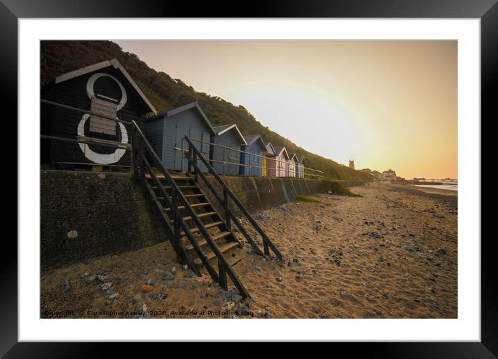 Sunset over Cromer beach huts Framed Mounted Print by Christopher Keeley