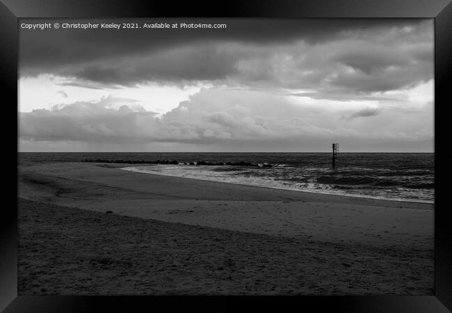 Moody, cloudy skies over Caister beach  Framed Print by Christopher Keeley