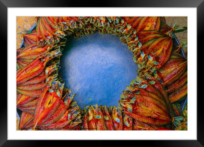 Salted fish offered on a street market in a decorative circle. Framed Mounted Print by Hanif Setiawan