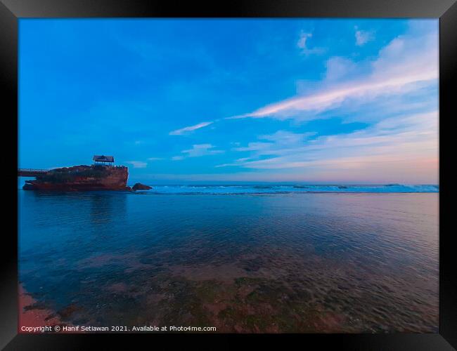 One rock on transparent sea water at Kukup beach. Framed Print by Hanif Setiawan