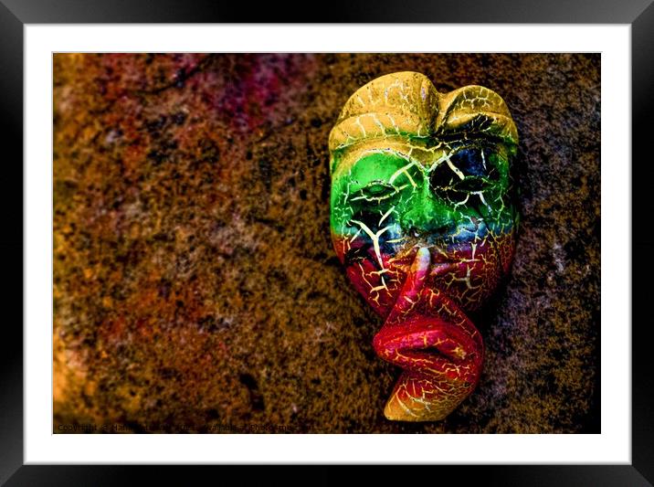 A Bali face mask with finger on its mouth. Framed Mounted Print by Hanif Setiawan