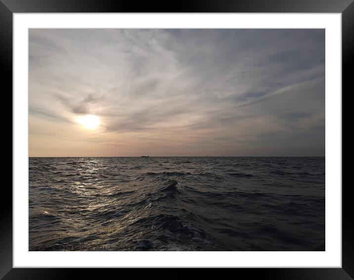Beautiful wavy ocean gleaming under the cloudy sky Framed Mounted Print by Hanif Setiawan