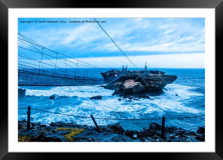 Swinging rope foot bridge to a rock island Framed Mounted Print by Hanif Setiawan